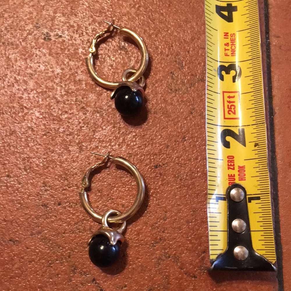 Gold tone hoop earrings with black dangle